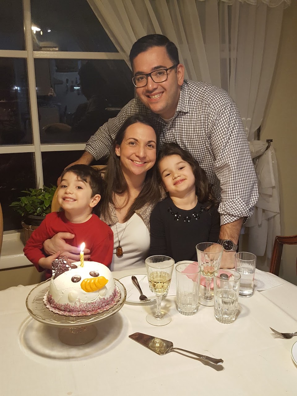 Dr. Calu with her husband, son (5), and daughter (7). Ideal days for them end with a delicious dinner and daily yoga practice.